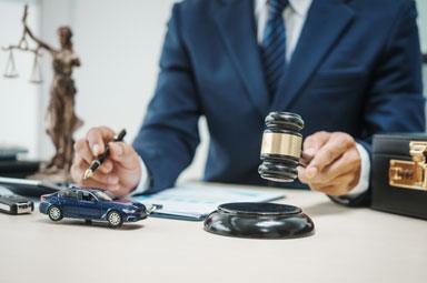 Gavel and toy car on desk illustrating car accident law concepts in Georgia.