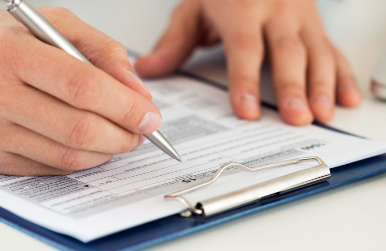 Person filling out tax form
