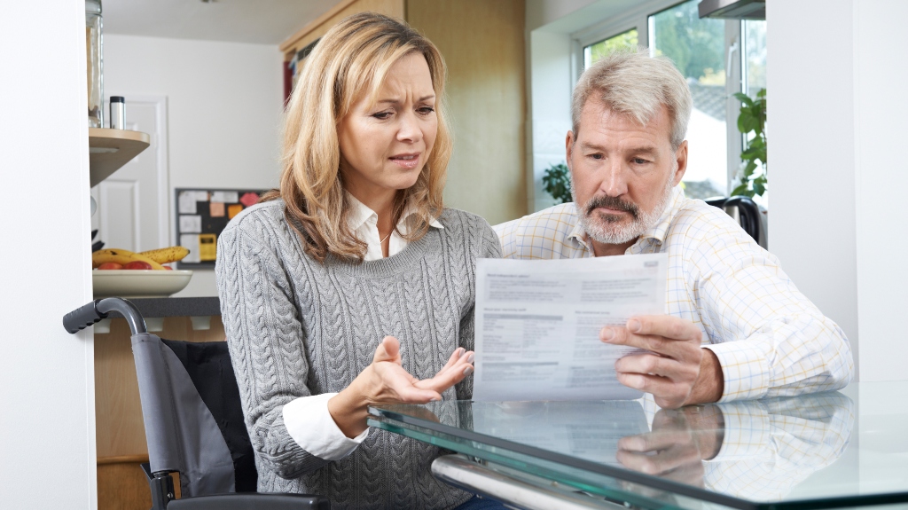 couple looking at paperwork in shock