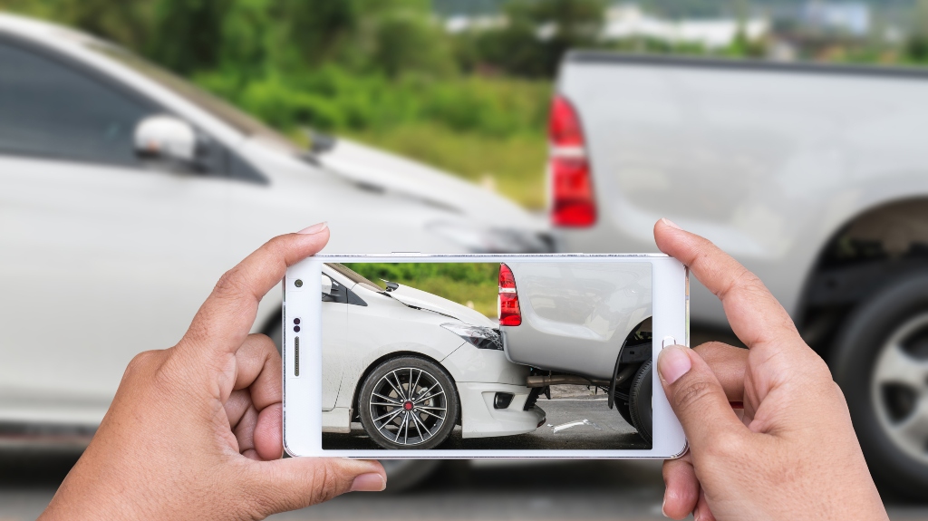 person taking a photo of a car accident
