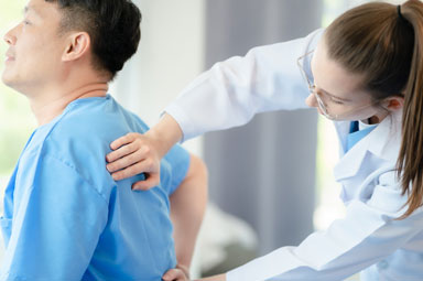 Doctor examining patient's back during a checkup, linked to Georgia personal injury claims deadlines.
