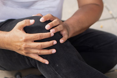 Injured individual holding leg; insights on choosing a personal injury lawyer in Georgia.